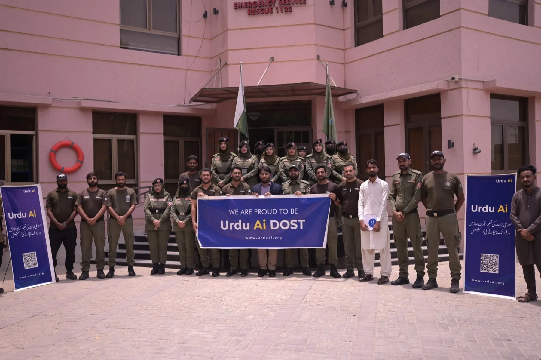 Rescue 1122 personnel and Urdu Ai Dosts standing outside the Hyderabad district station