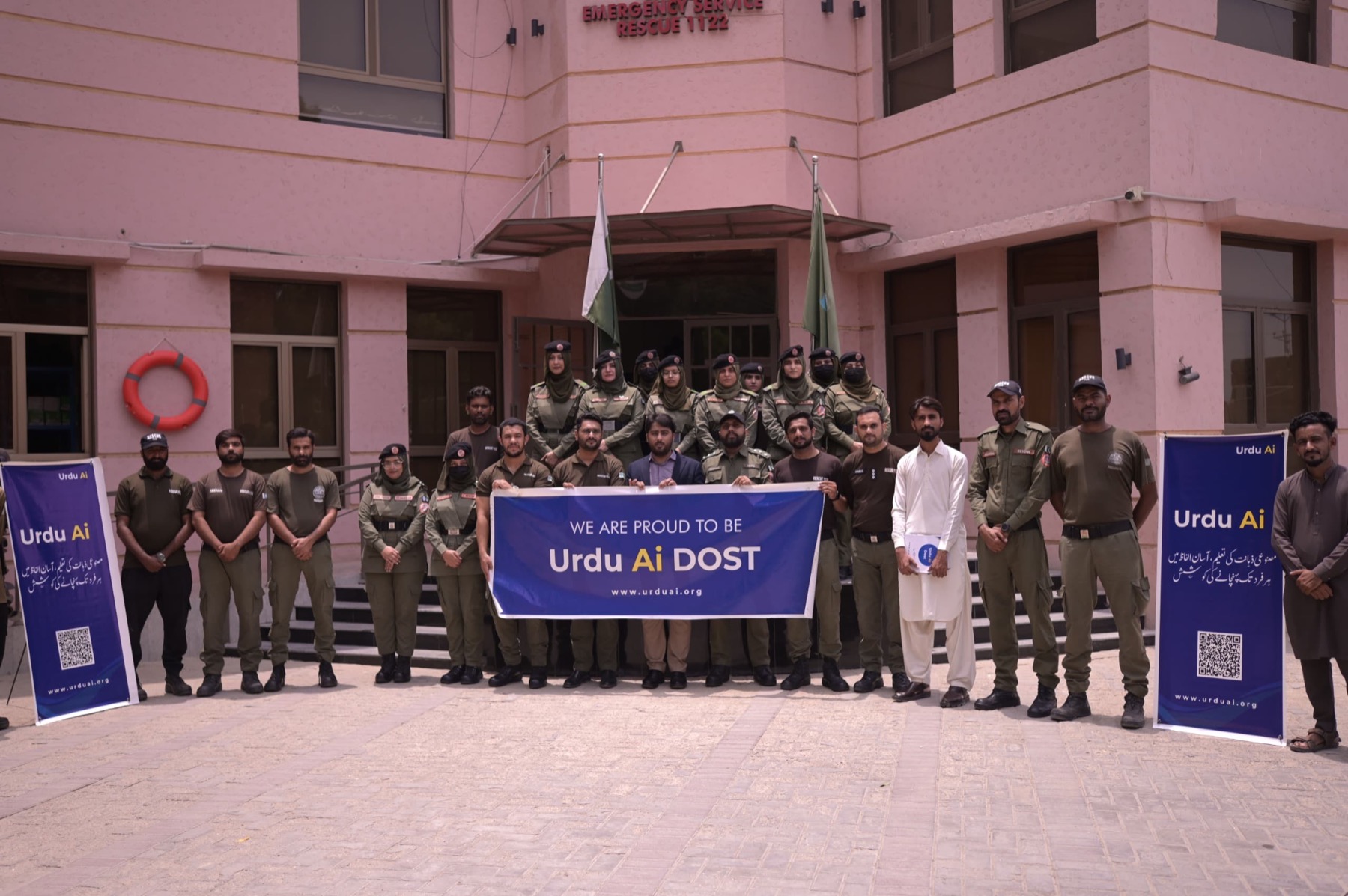 Rescue 1122 personnel and Urdu Ai Dosts standing outside the Hyderabad district station